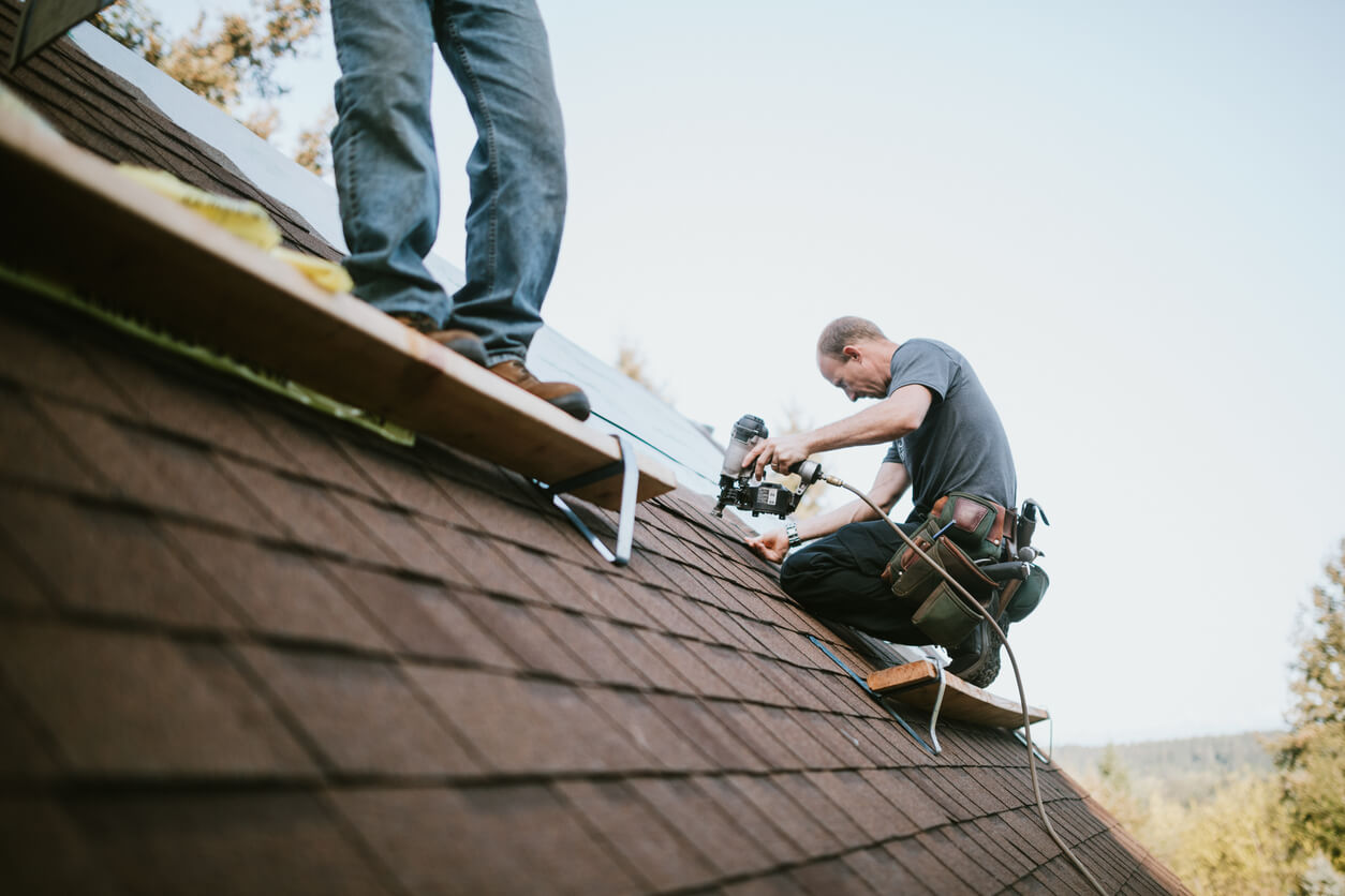 Two guys building a new roof